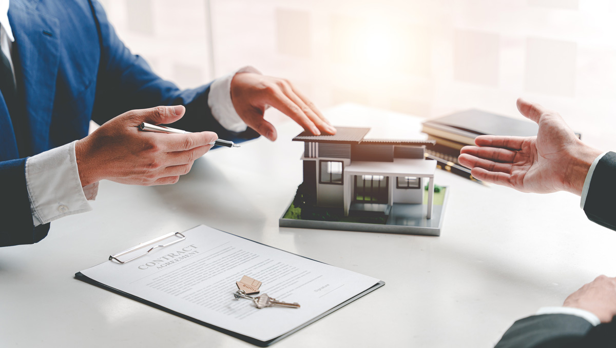 Real estate agent presenting sample home models to clients for loan against property