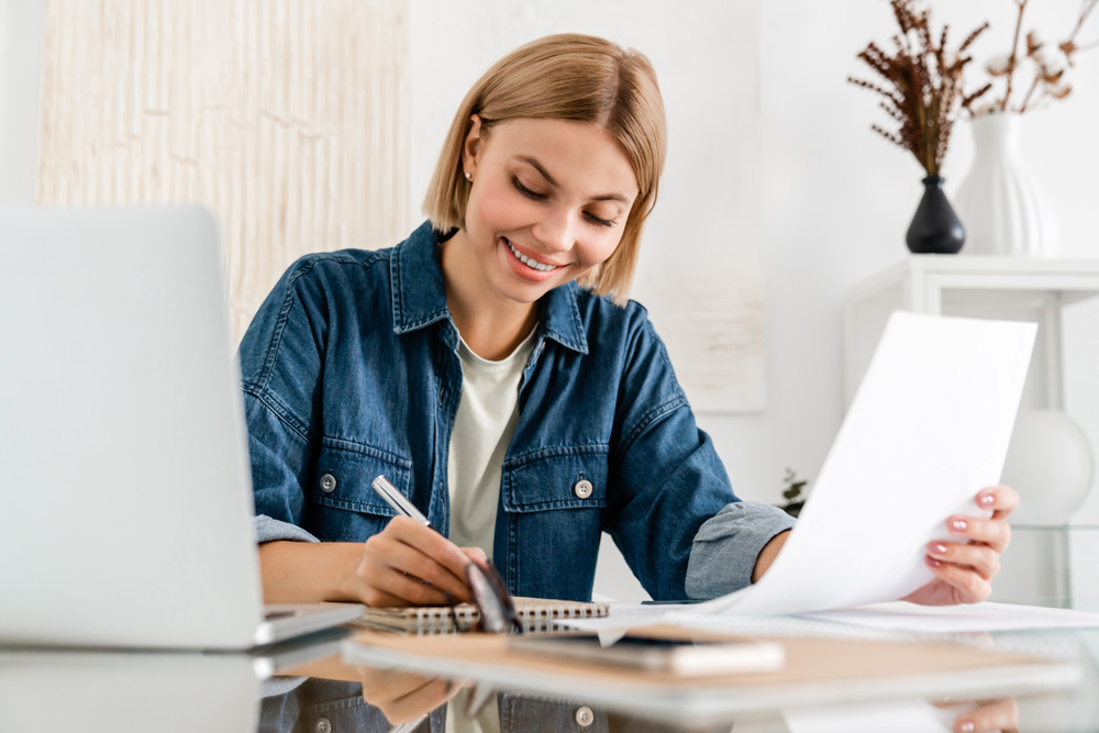 Woman taking notes on benefits of home loan for women