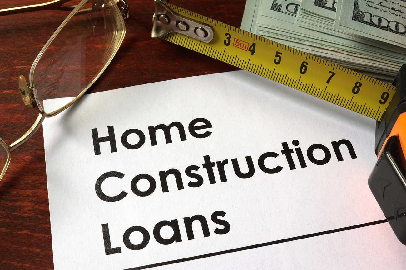 Wooden background with document discussing home construction loans