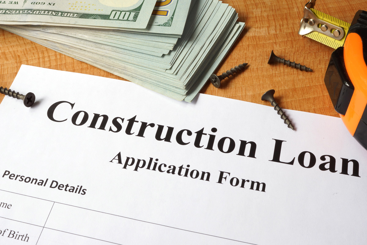 Wood table with paperwork for a home construction loan