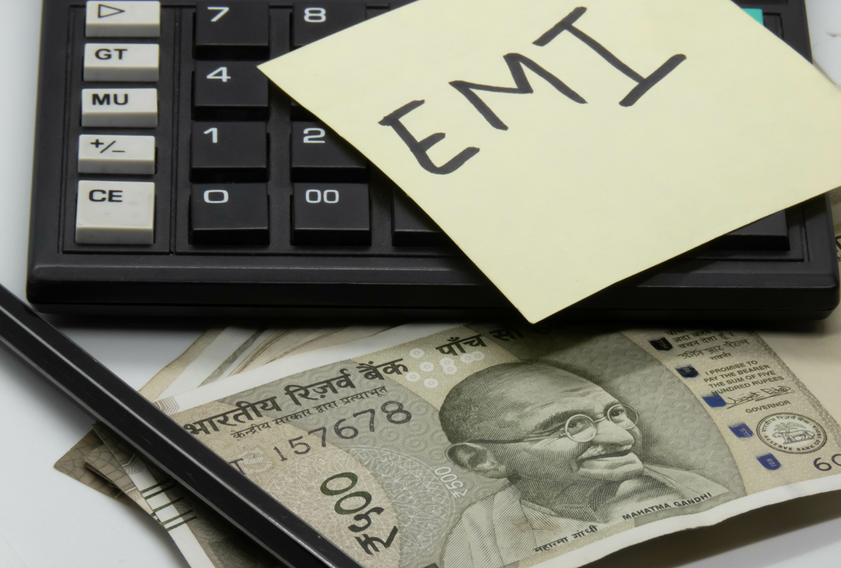 EMI calculation concept with calculator and spectacles